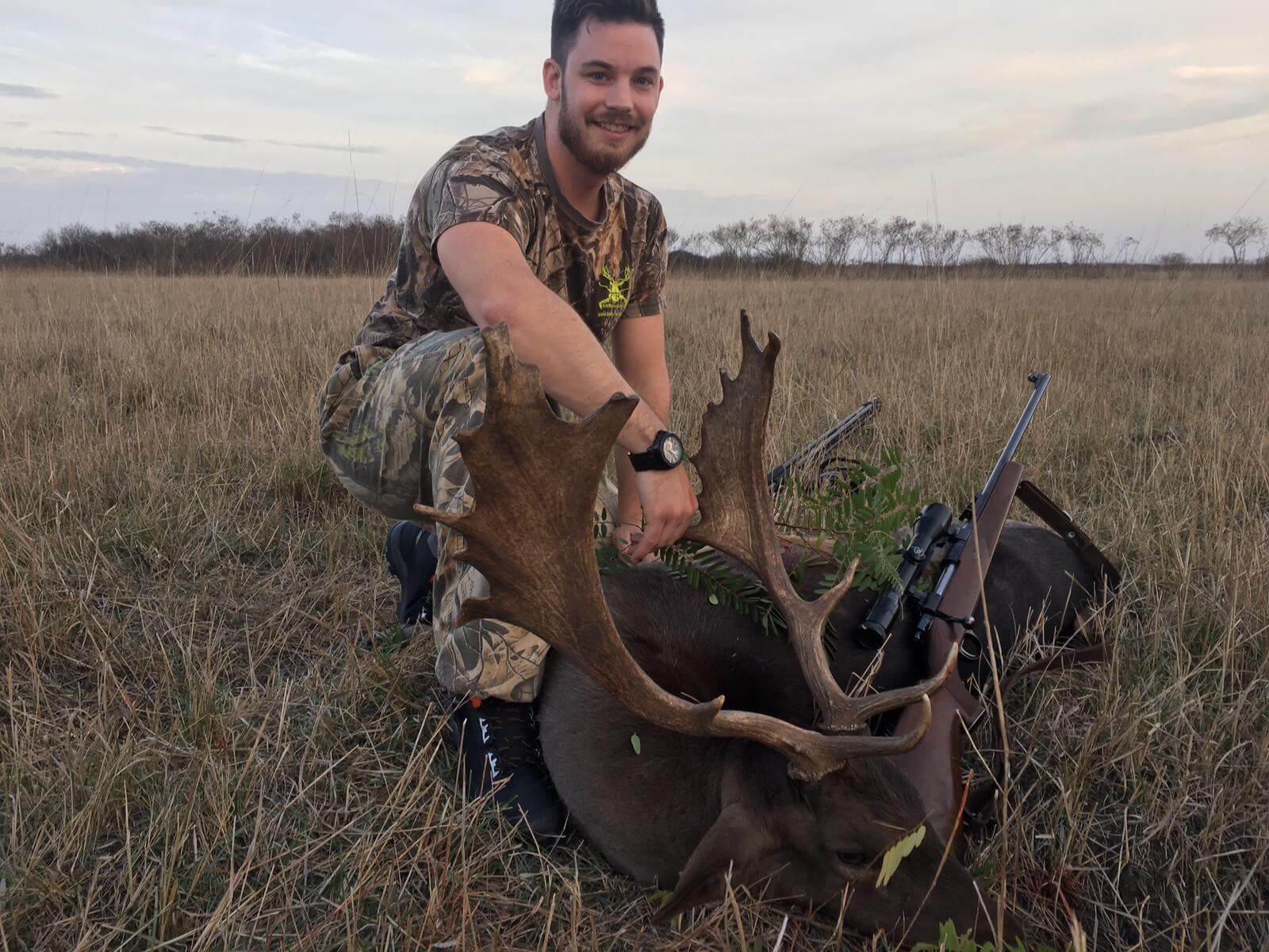 Alex kneeling next to the fallow deer he took with Florin